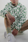 Person wearing a green and white patterned outfit on a white background
