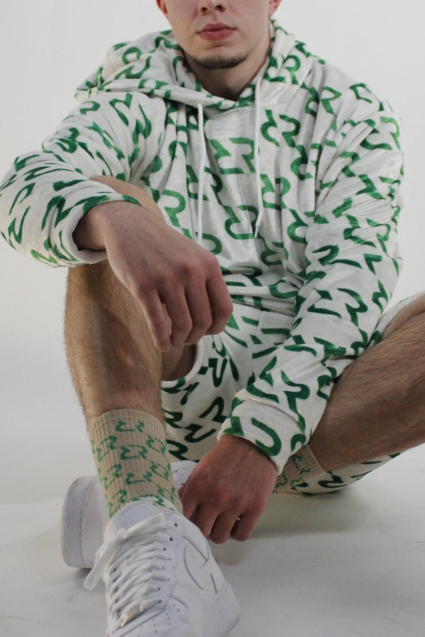 Person wearing a green and white patterned outfit on a white background